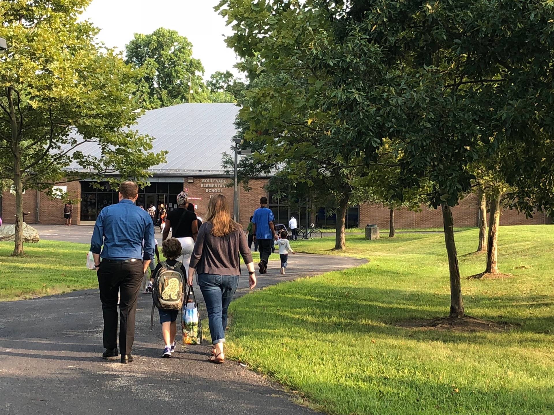 Students and parents walking into building