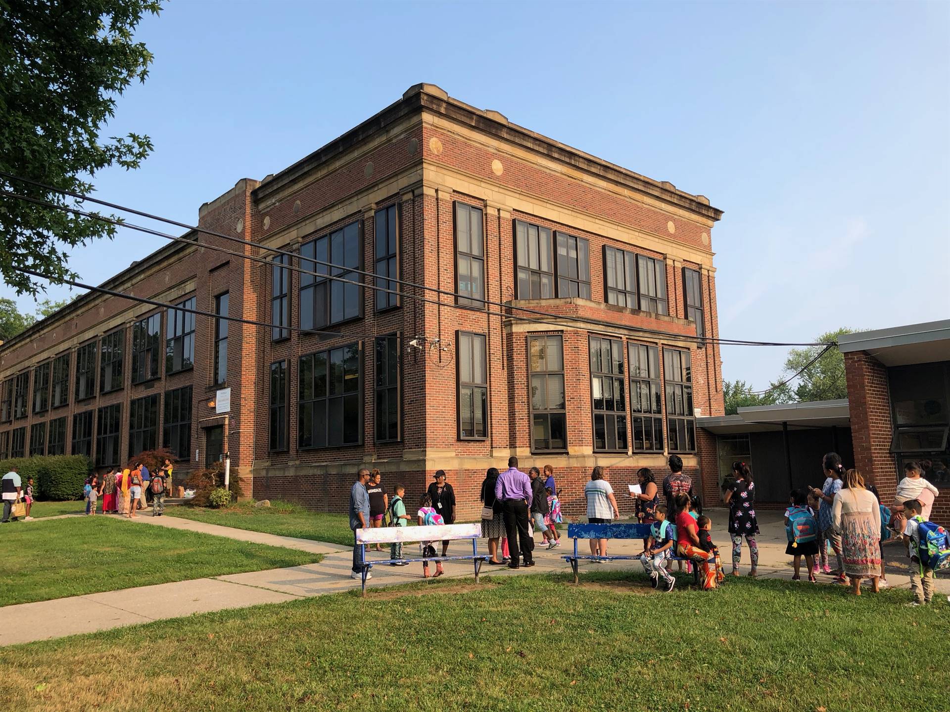 Students and parents waiting outside of building