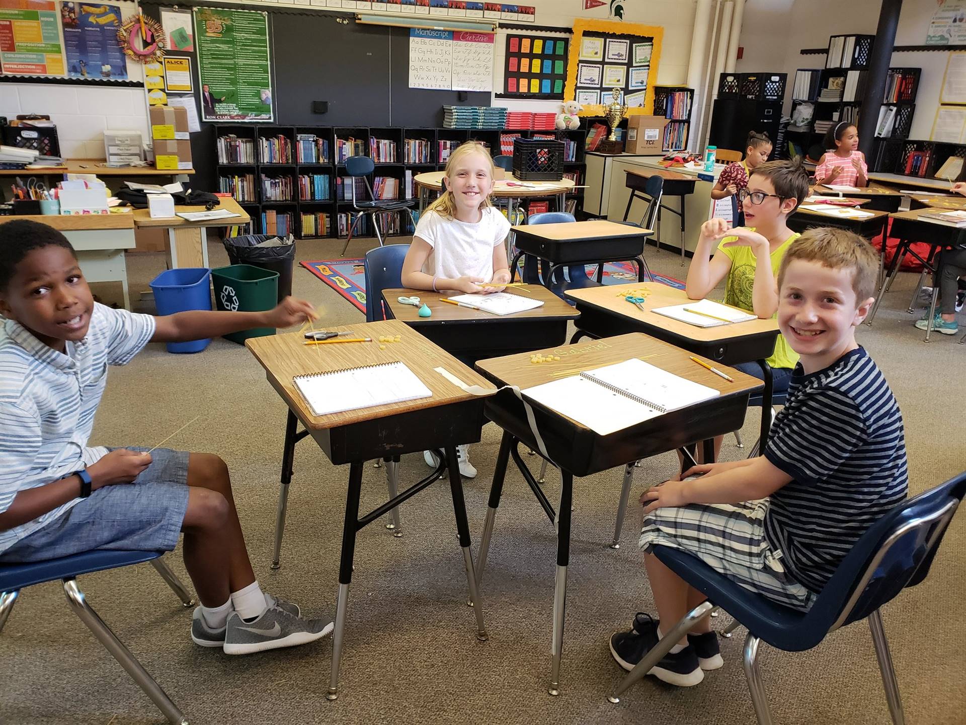 Students smiling at desks