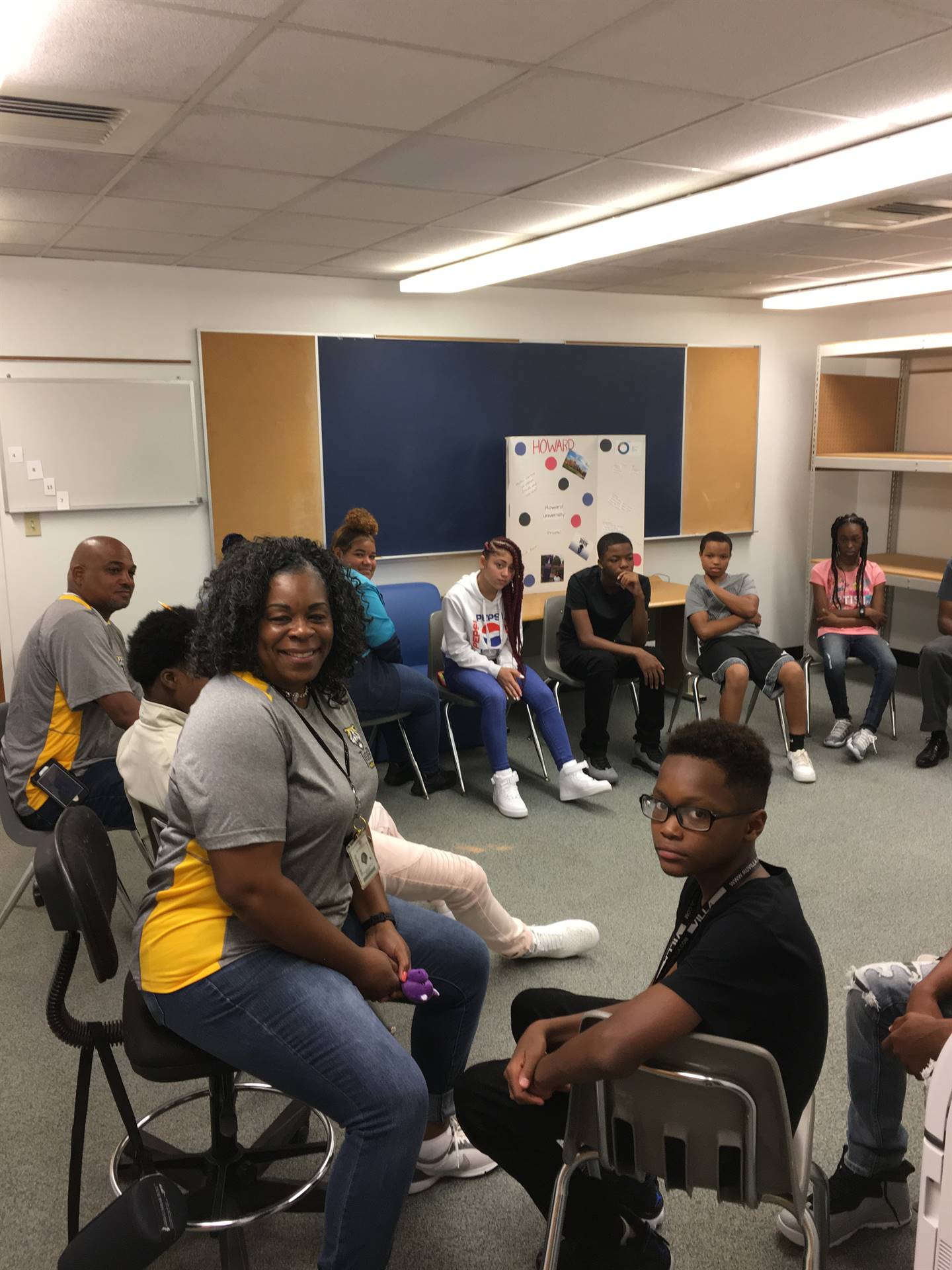 Students and teachers sitting in circle