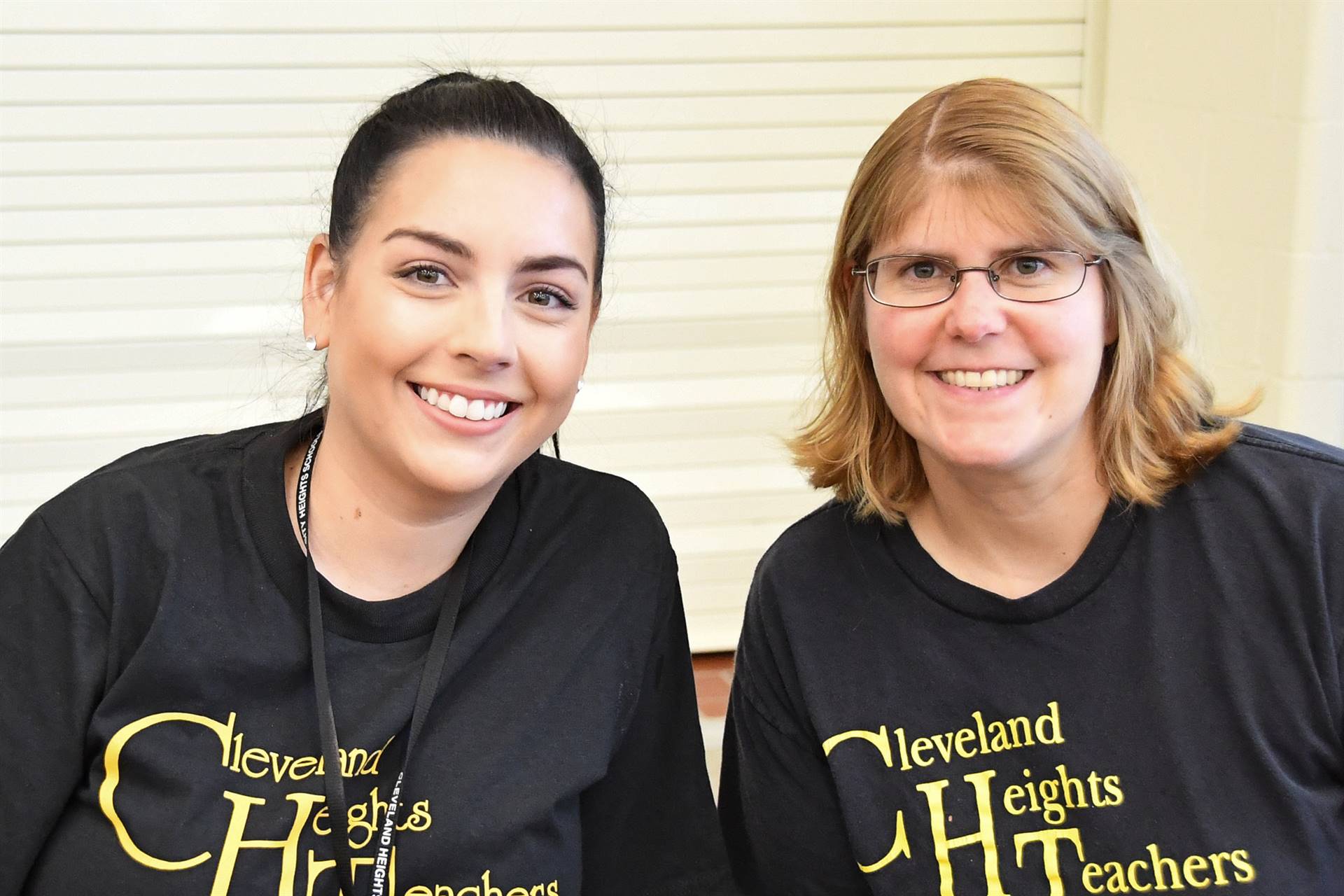 Two staff members smiling