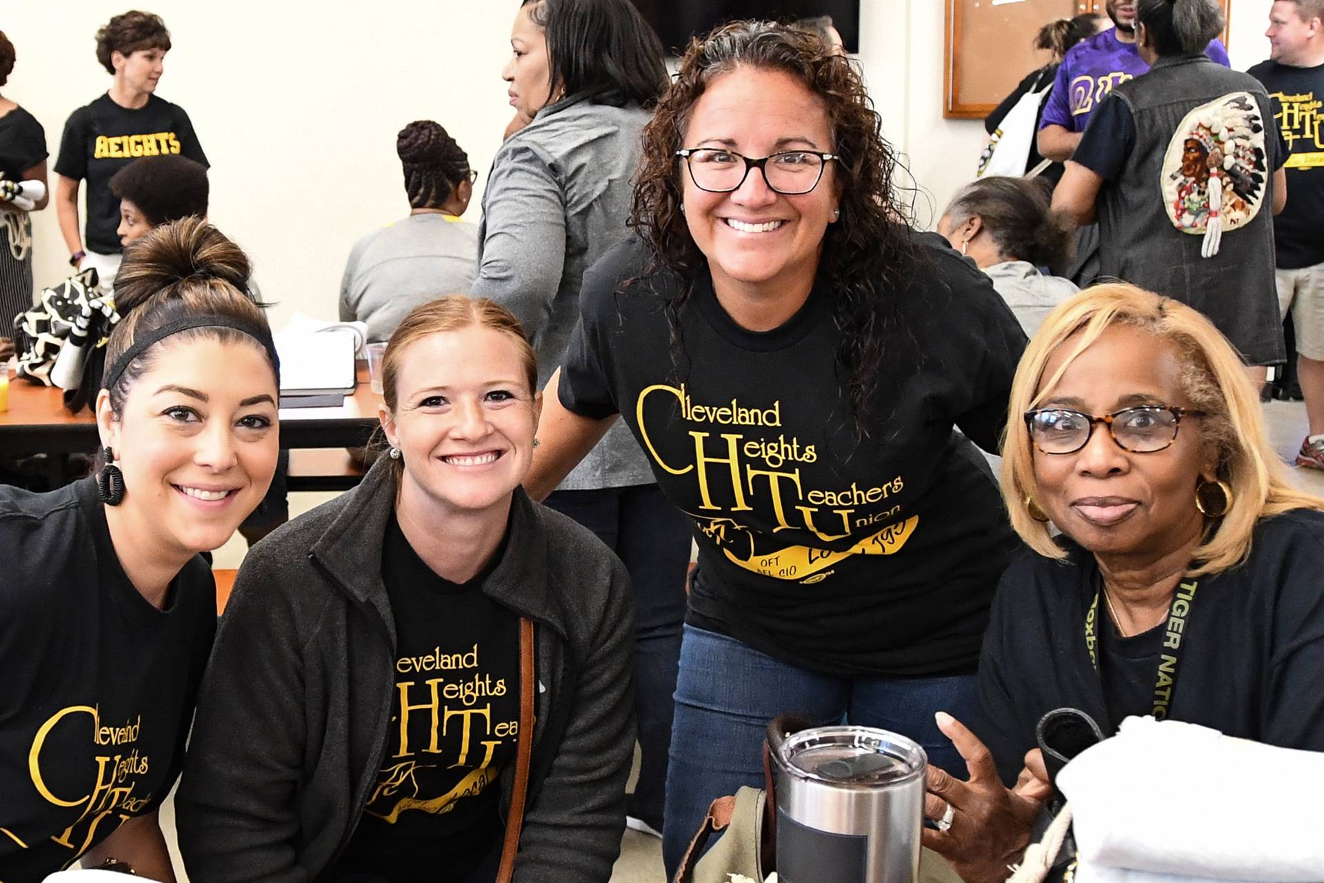 Staff smiling at table