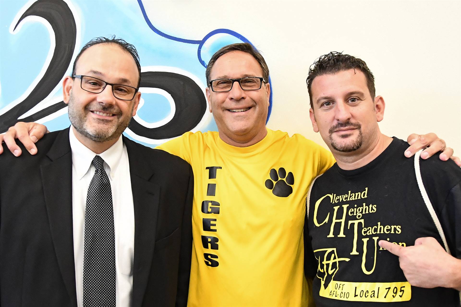 Three staff members smiling