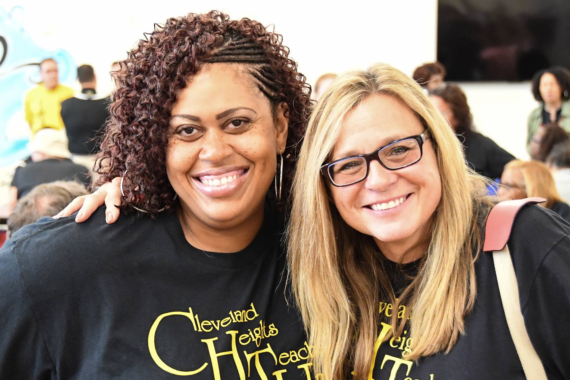 Two staff members smiling