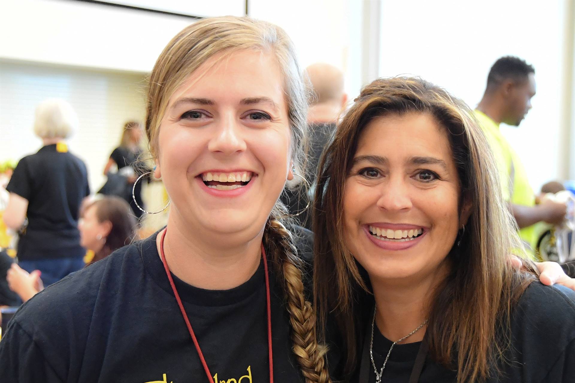 Two staff members smiling