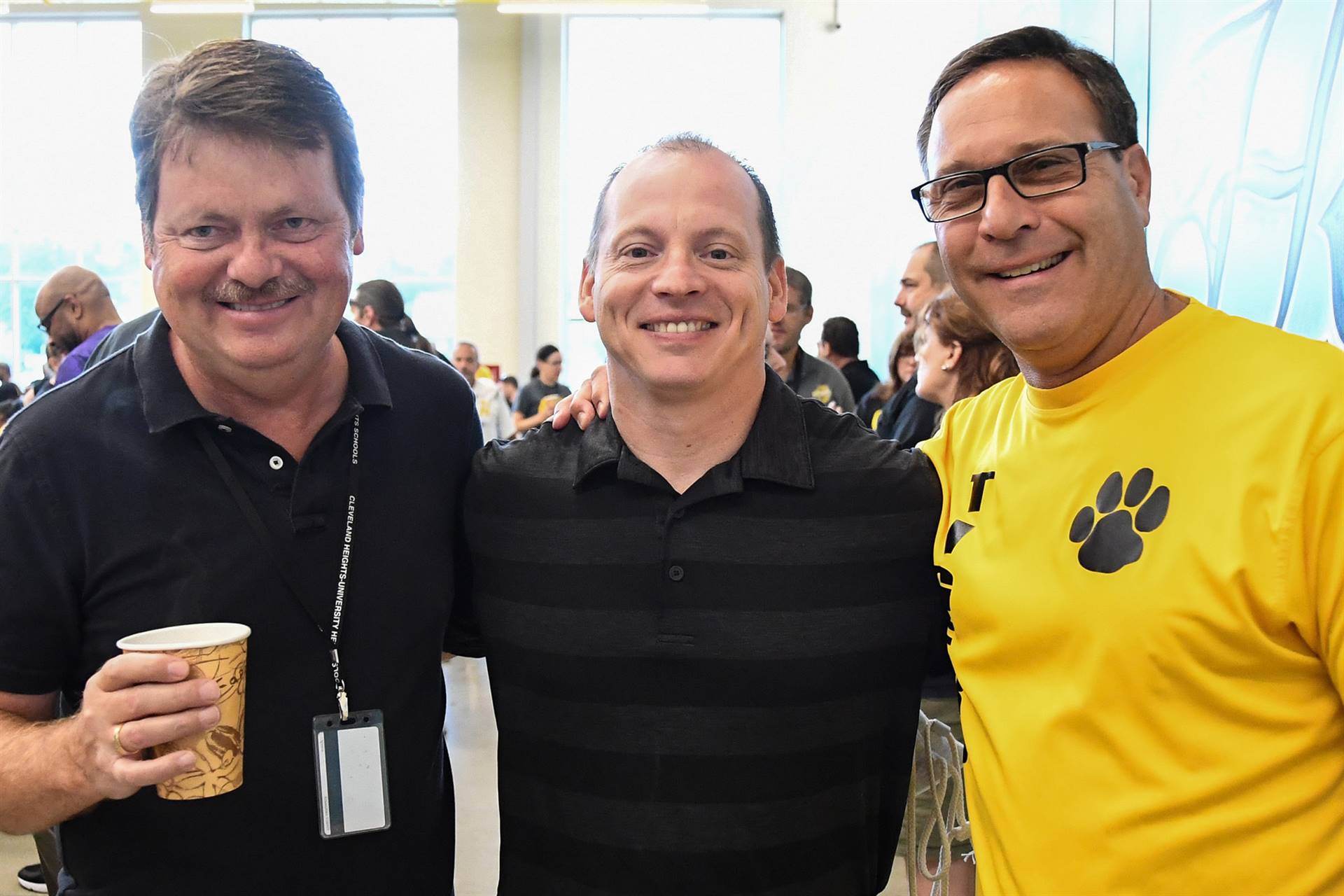 Three staff members smiling