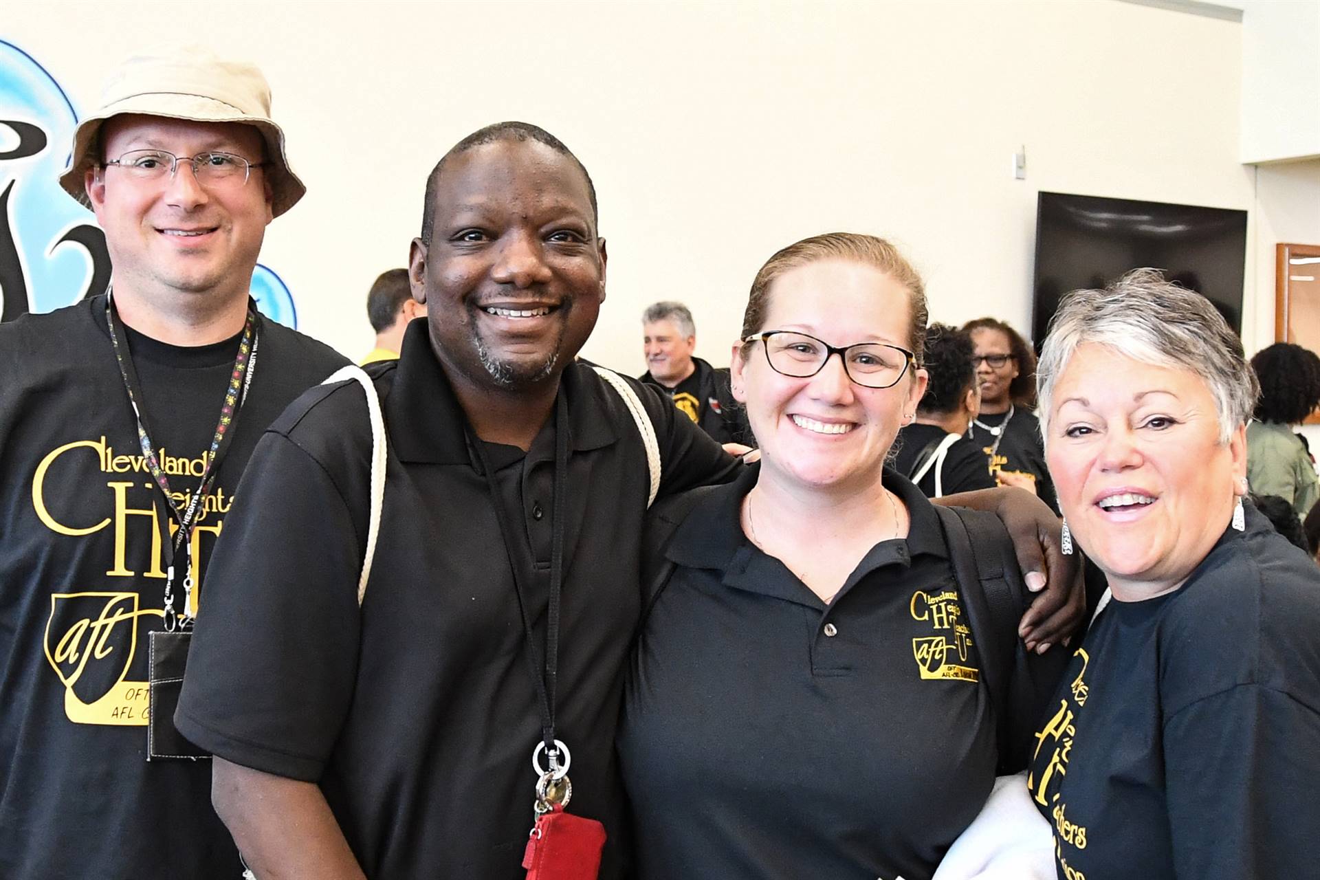 Four staff members smiling