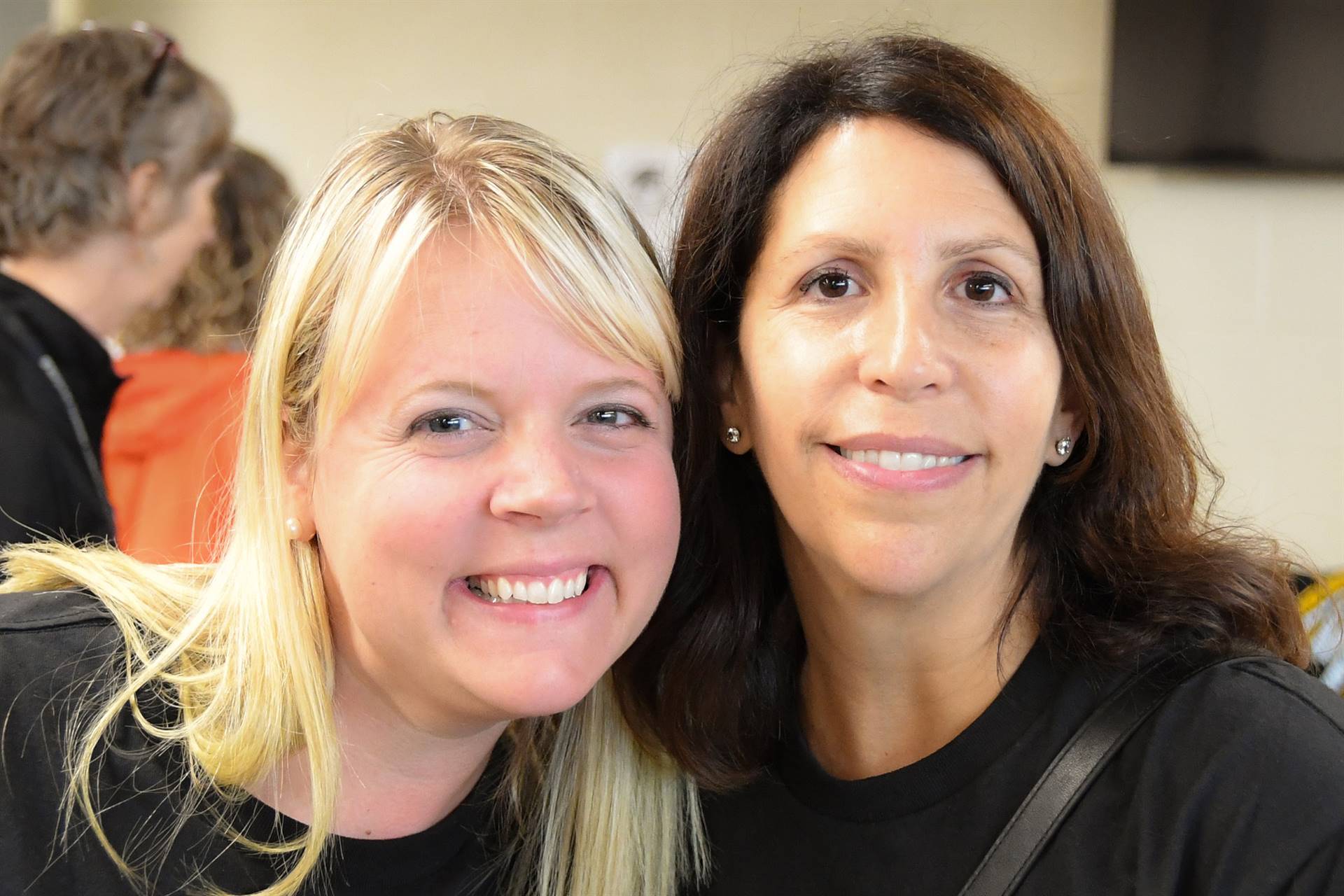 Two staff members smiling