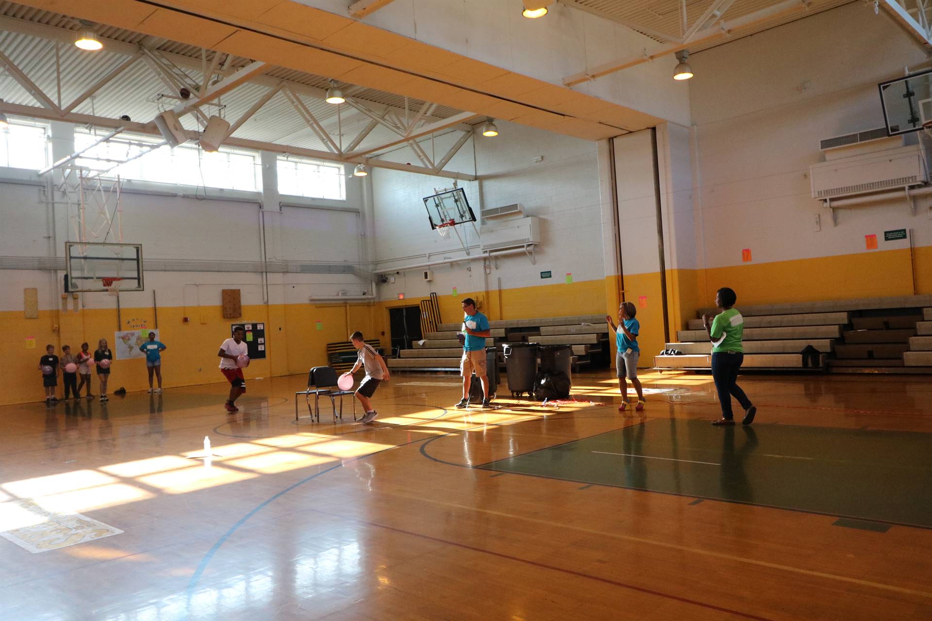 Students playing game with chairs and balloons