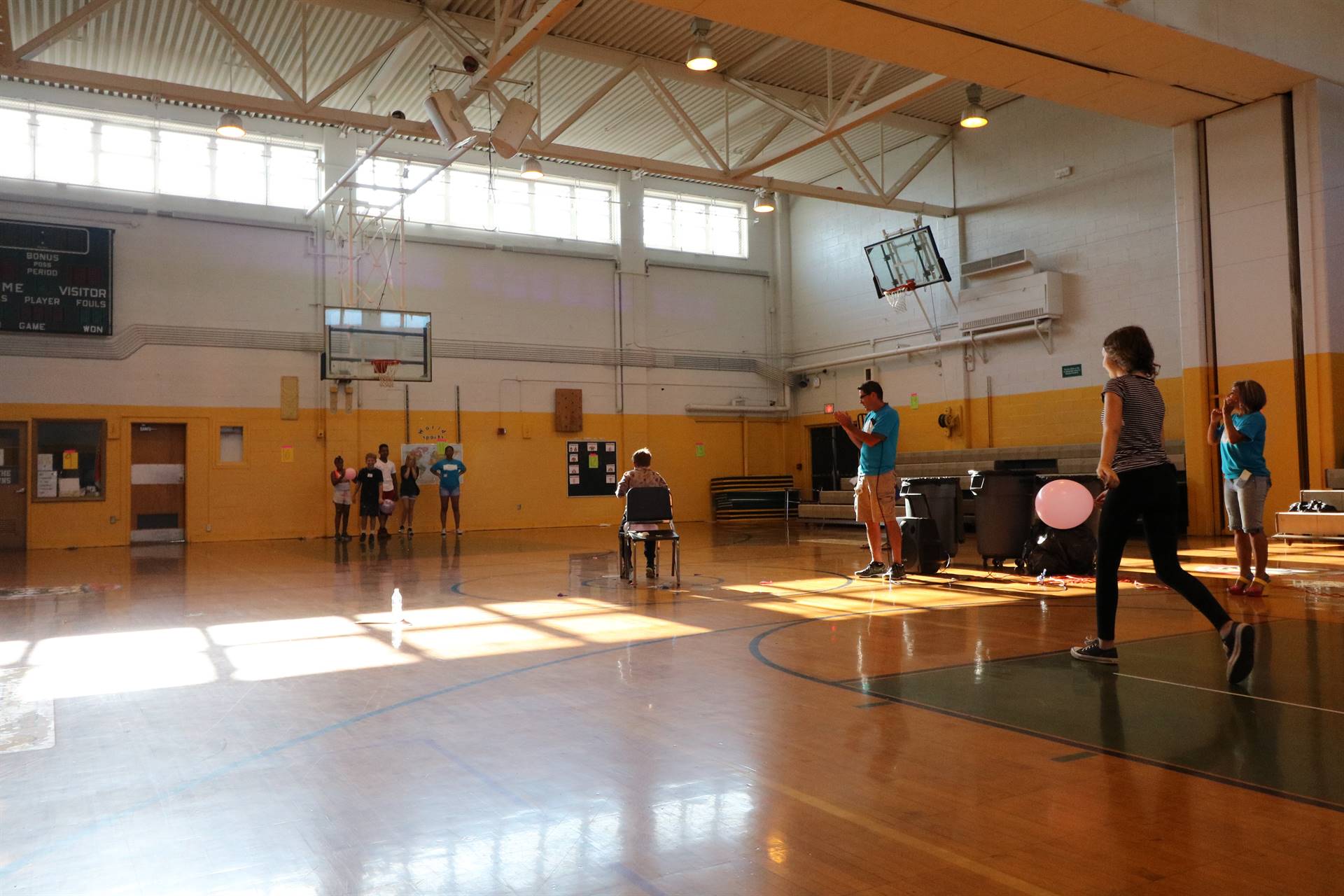 Students playing game with chairs and balloons