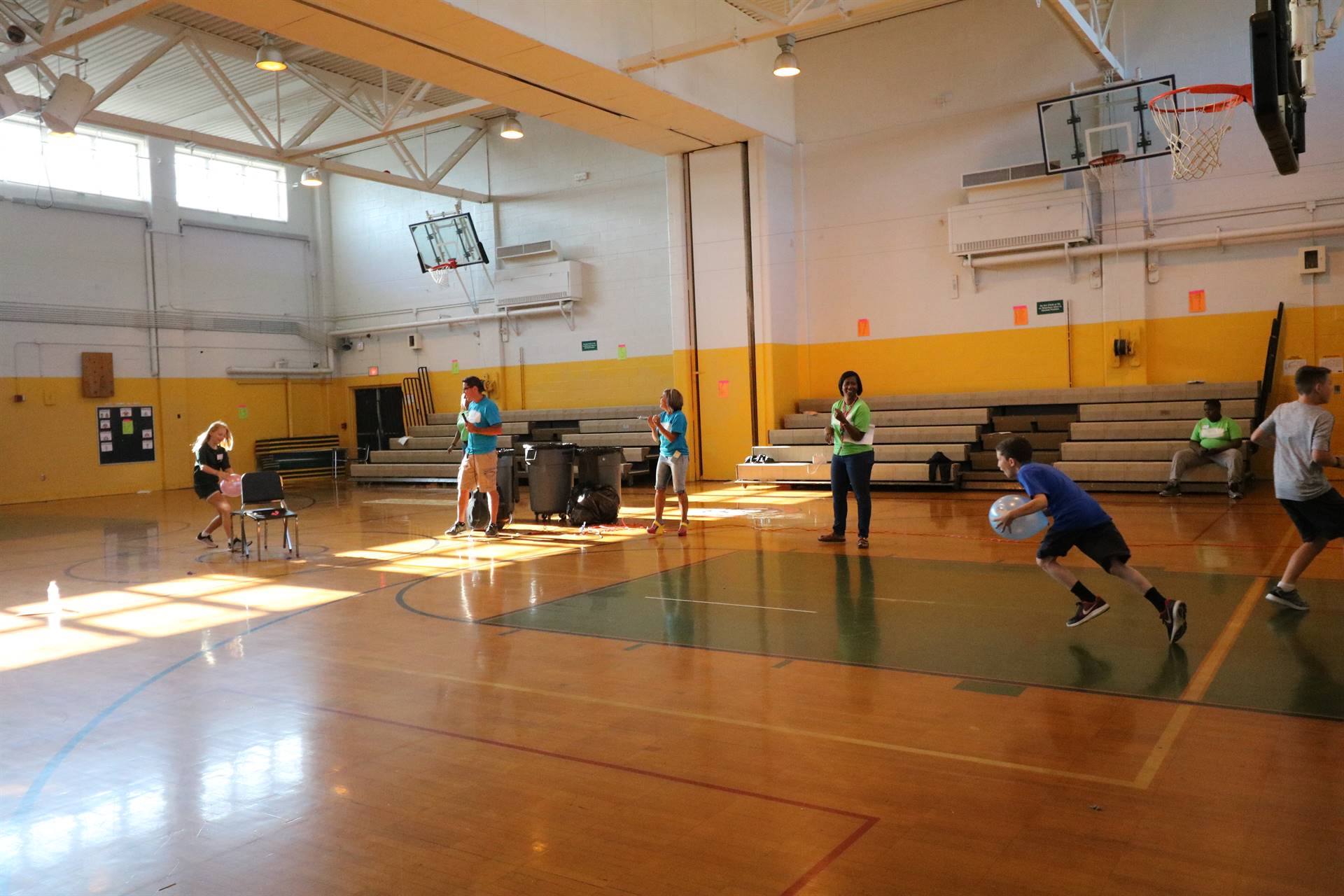 Students playing game with chairs and balloons