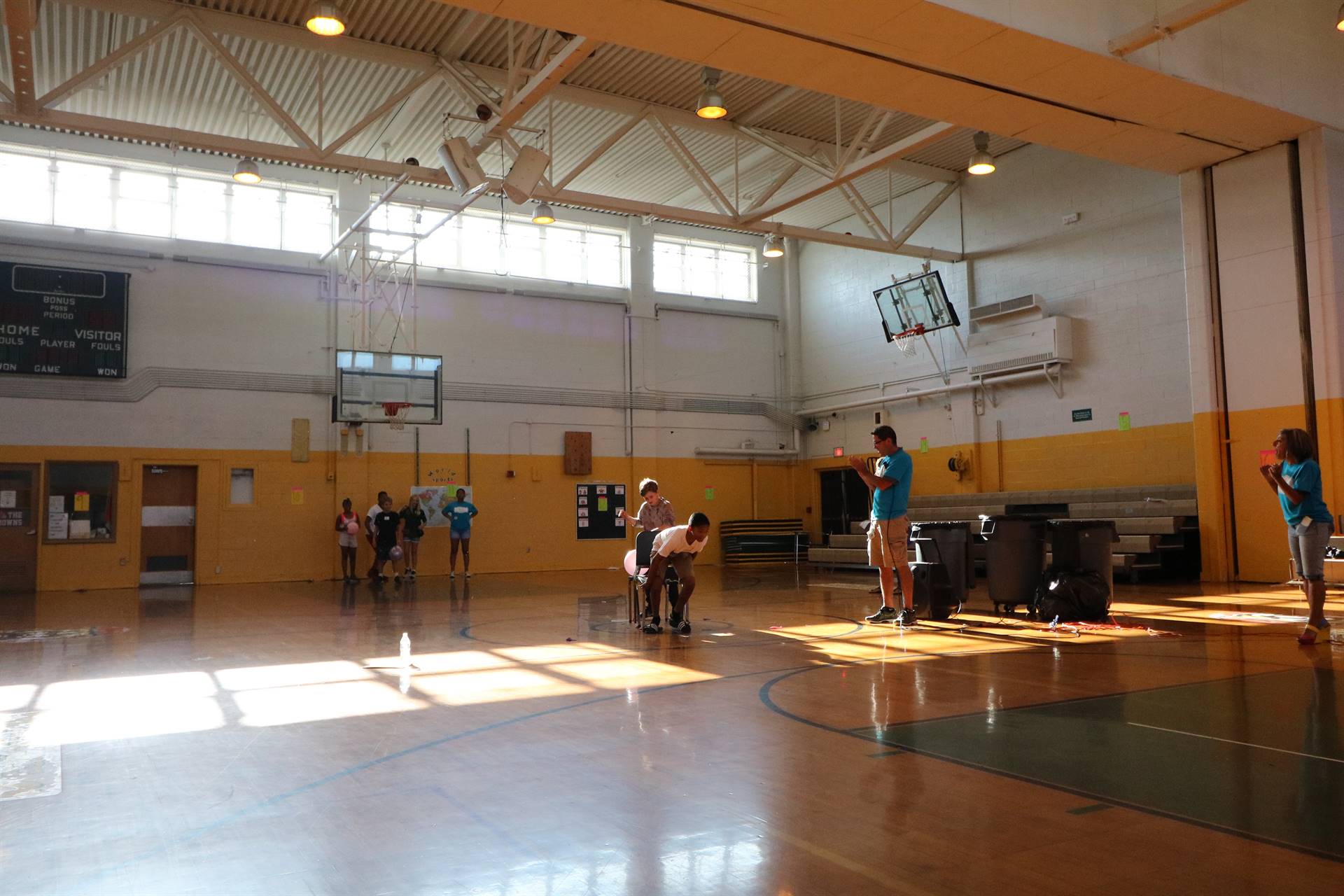 Students playing game with chairs and balloons