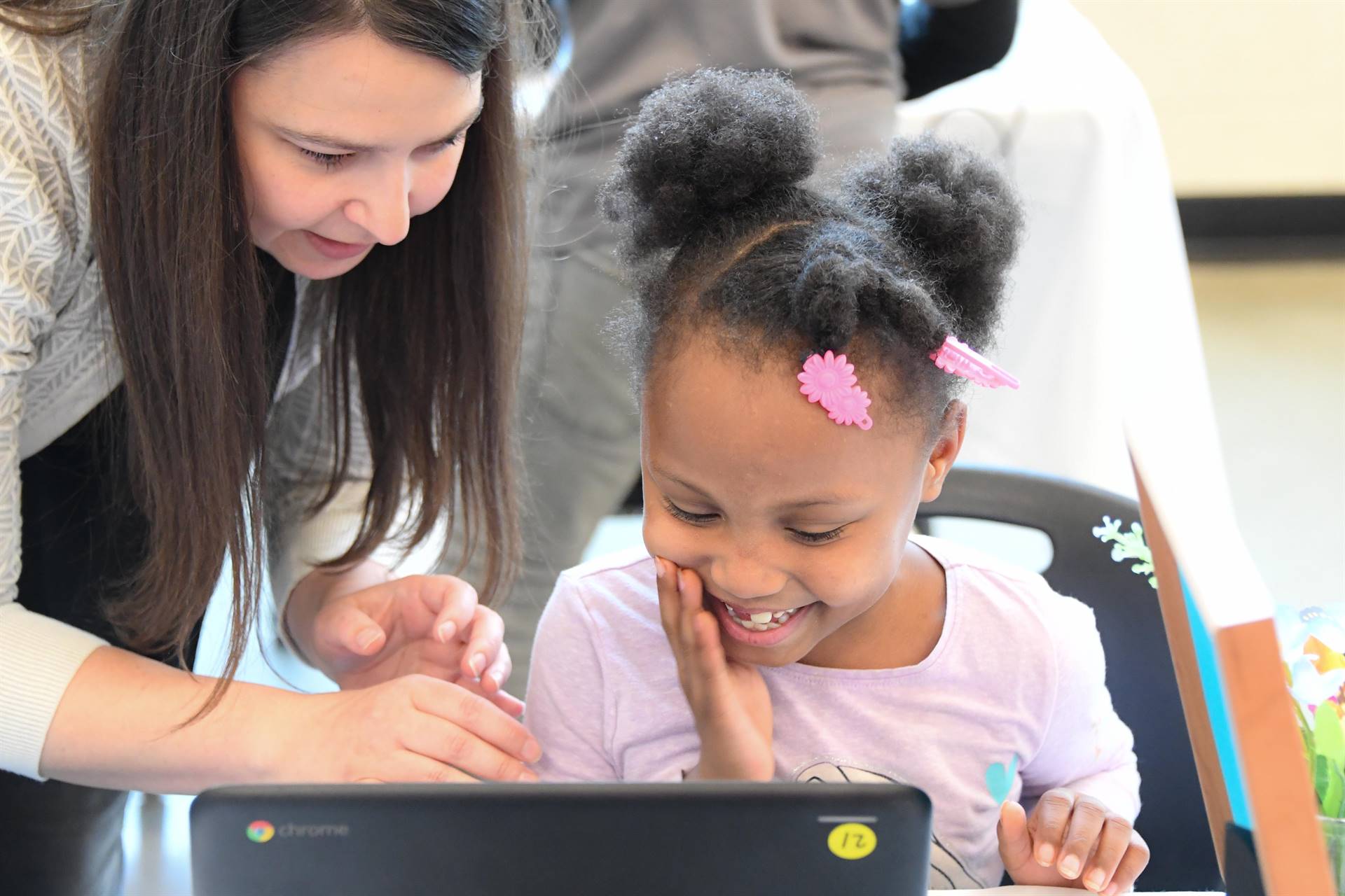 Woman with child working at a computer