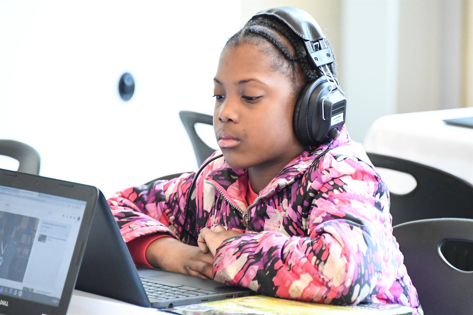 Child at computer with headphones