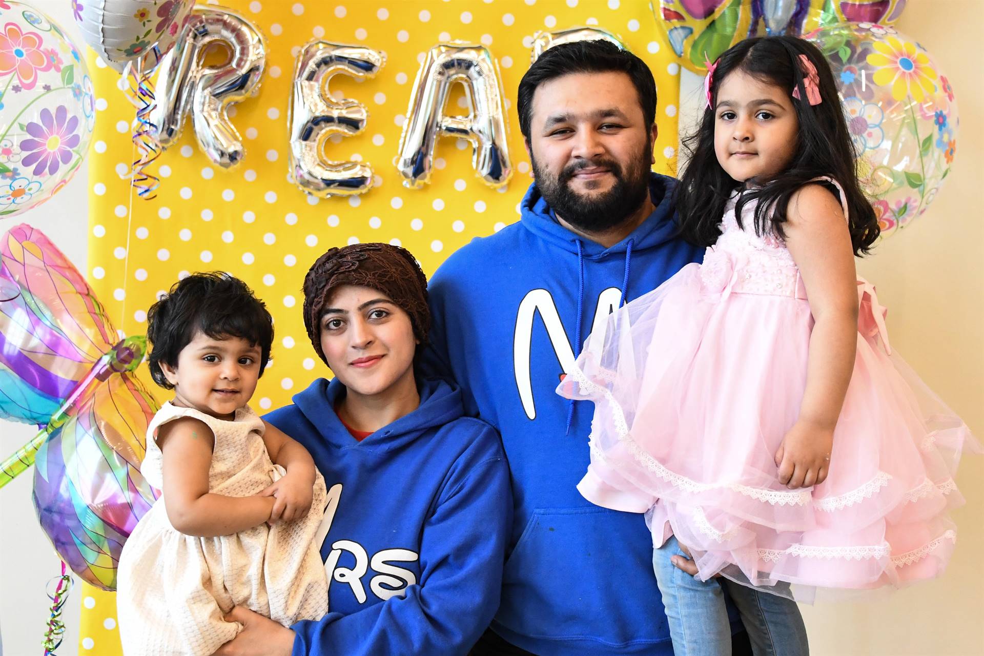 Family in front of yellow backdrop