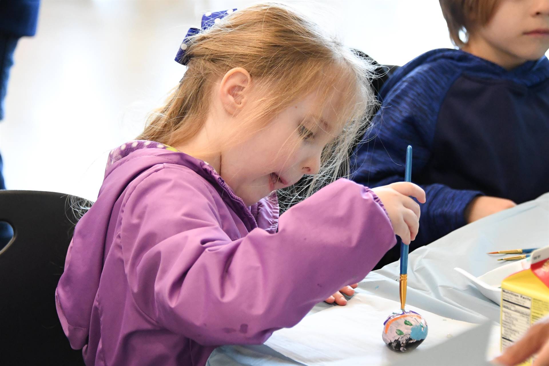 Girl painting egg