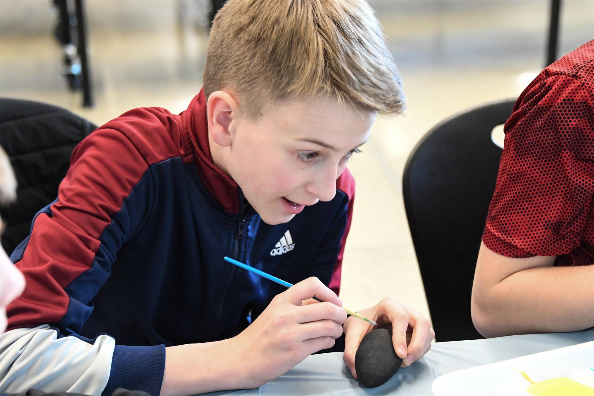 Boy painting egg