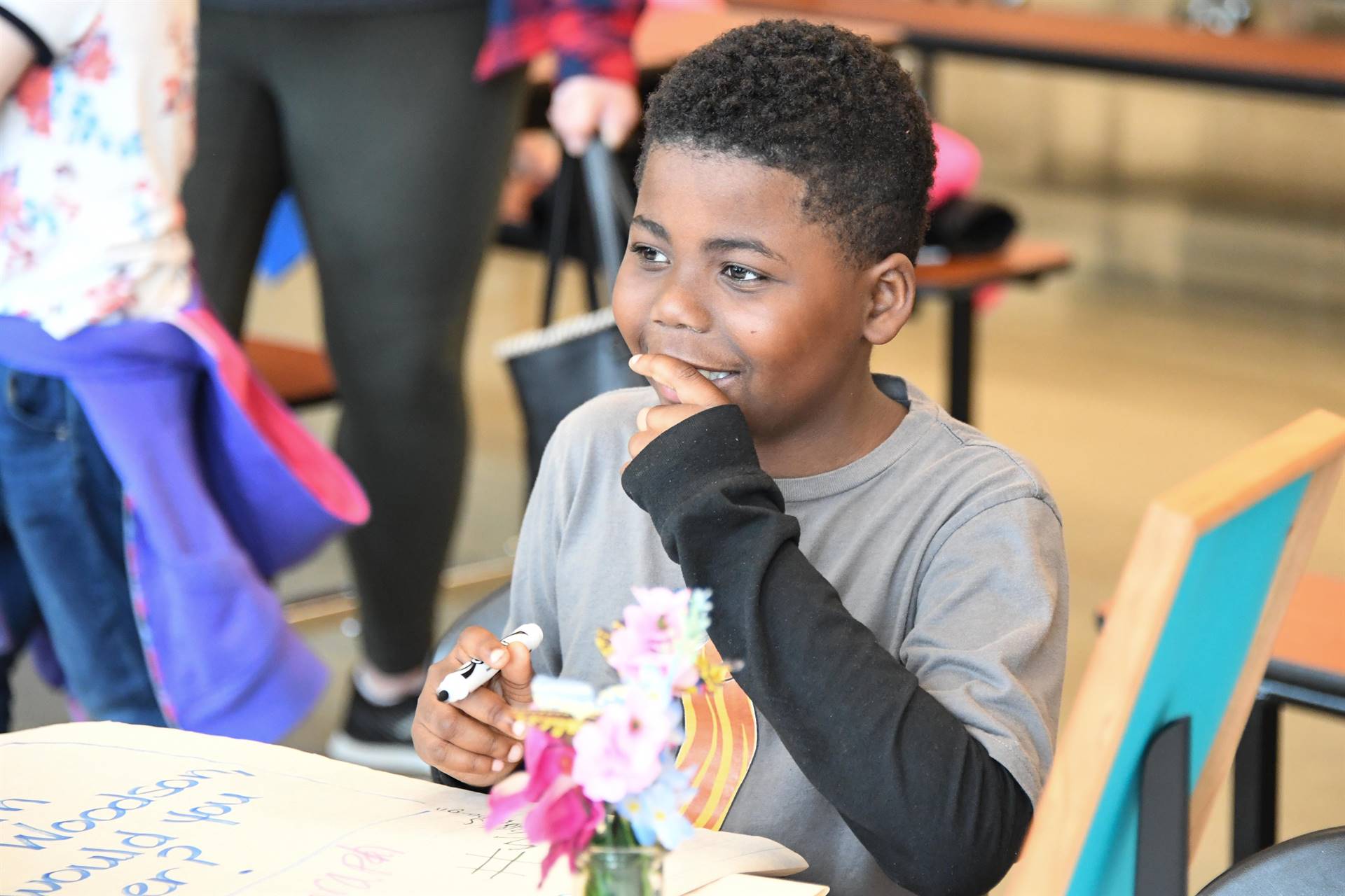 Boy smiling and holding marker