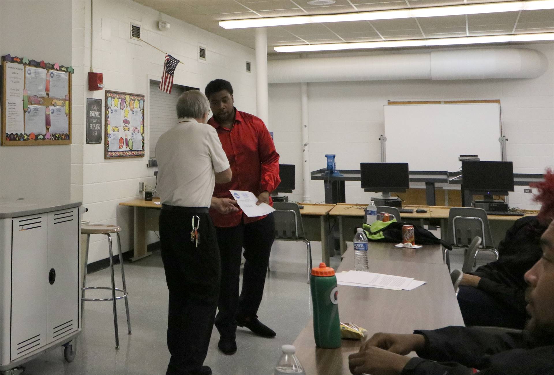 man shaking hands with student