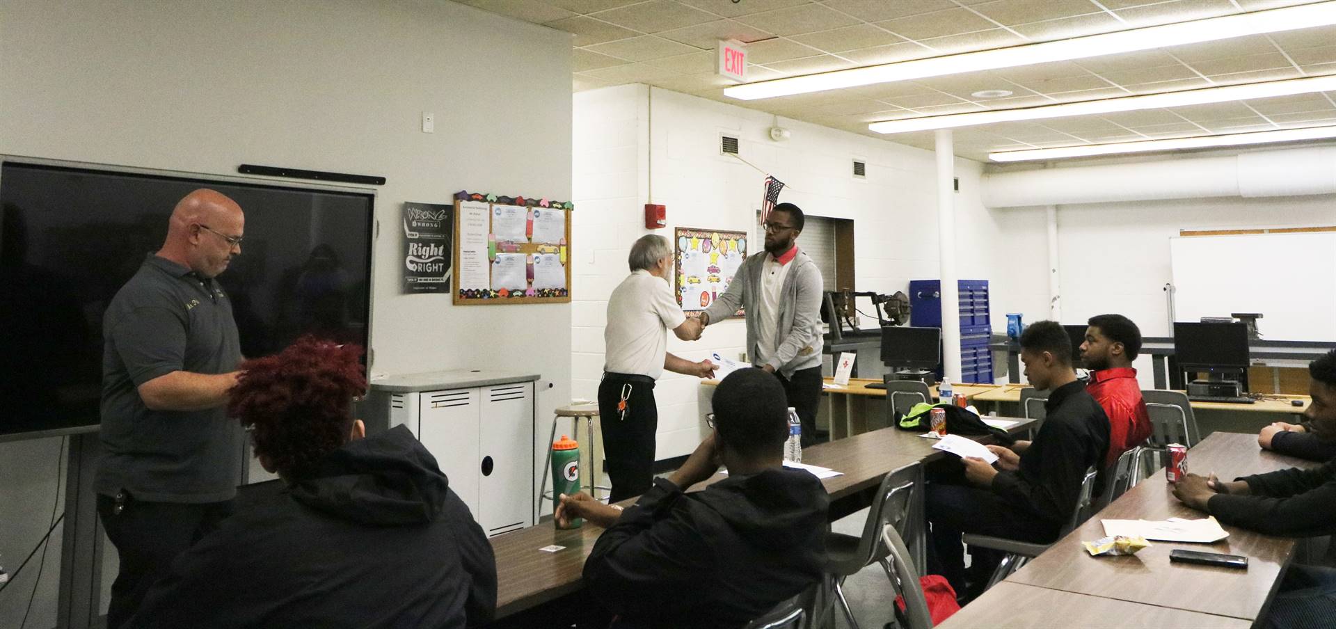 man shaking hands with student