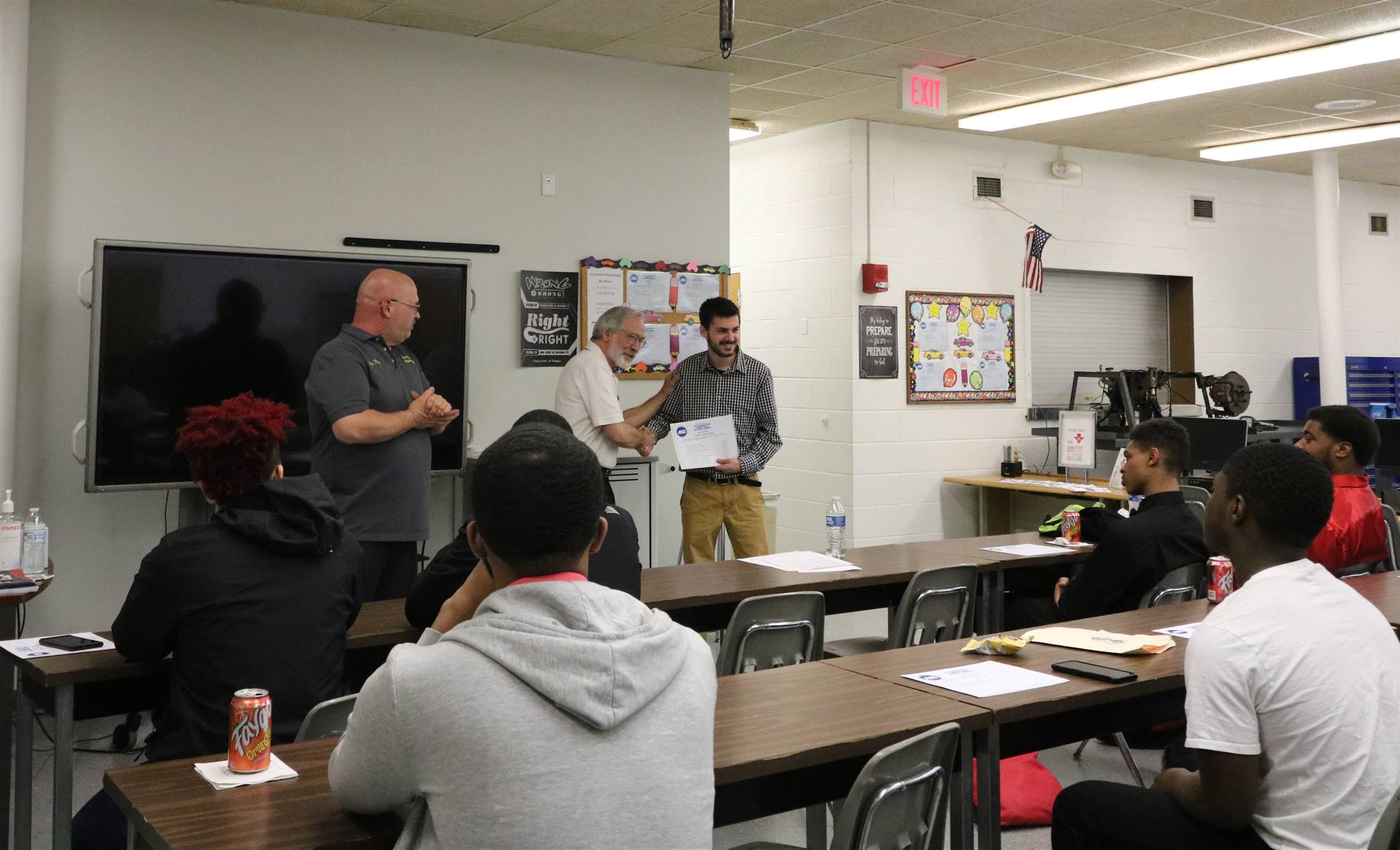 man shaking hands with student