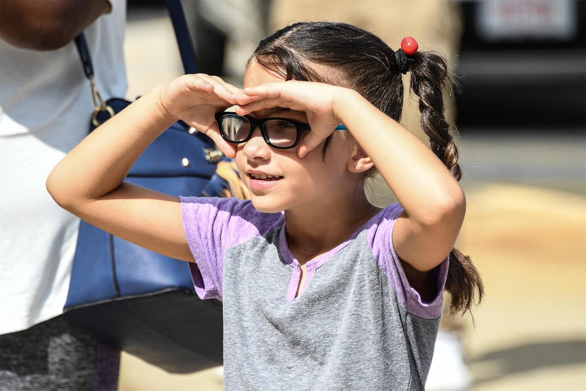 girl looking with hands over eyes