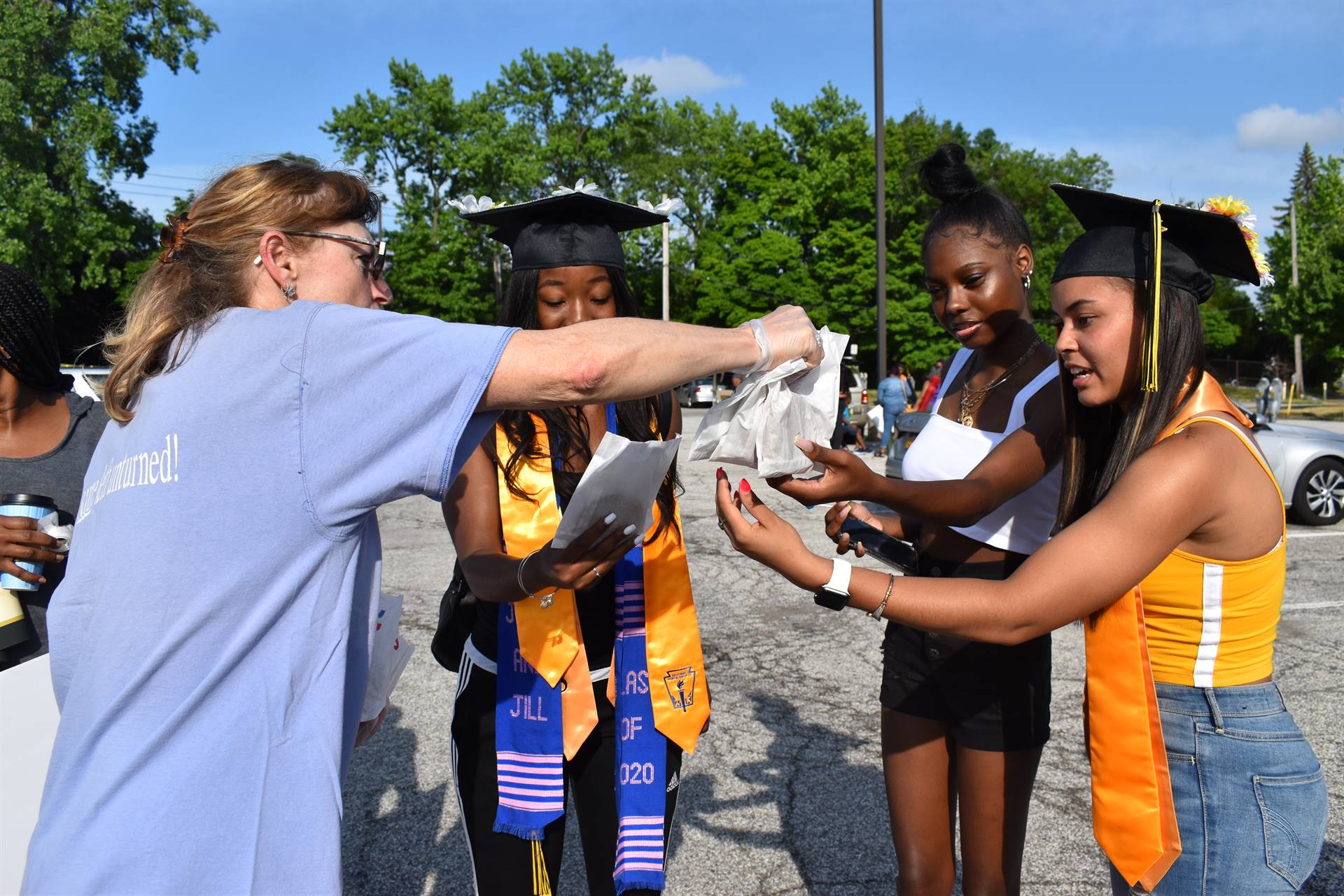 The Stone Oven co-owner Tatyana Rehn  distributes cookies to the graduates.