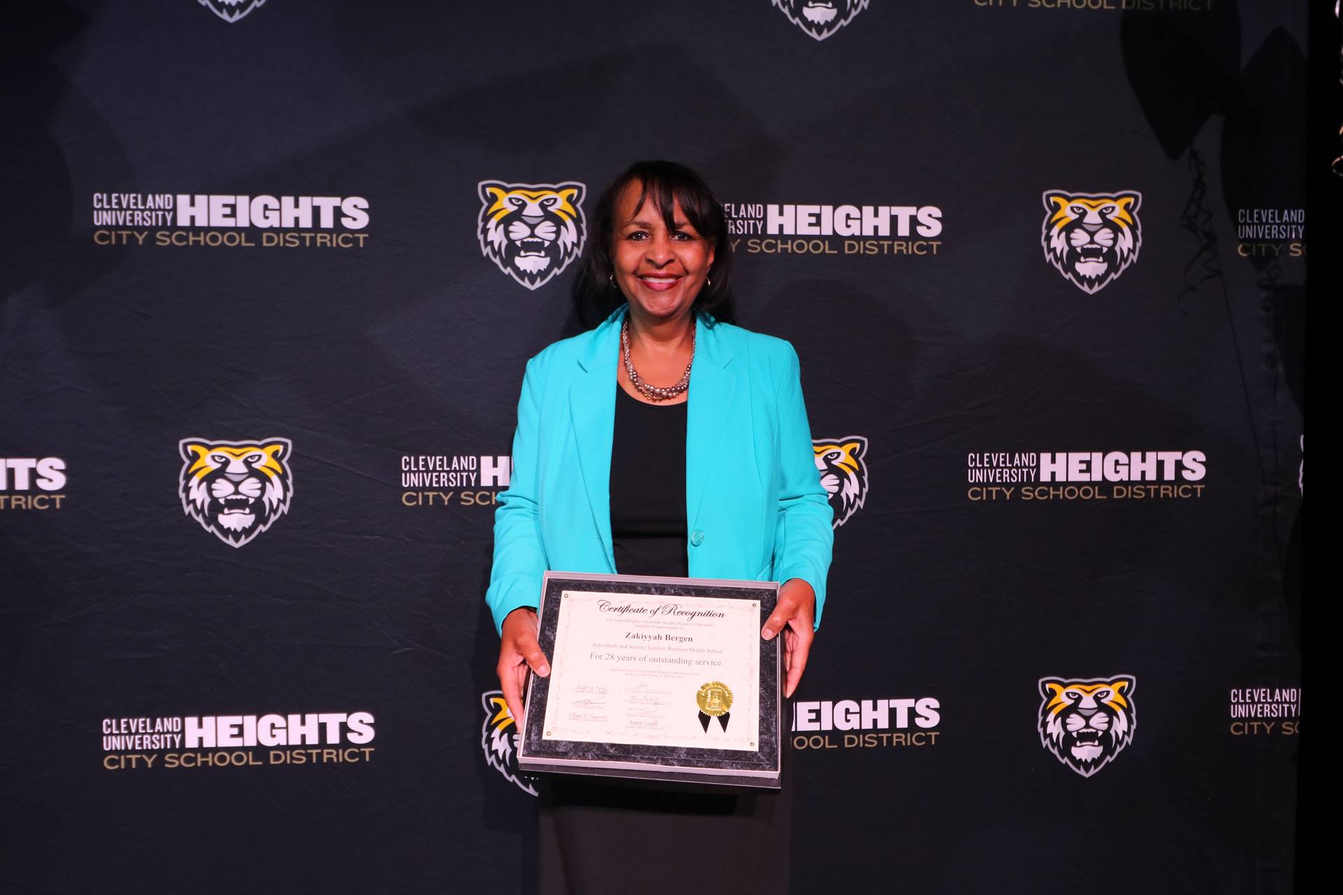 staff member holding award