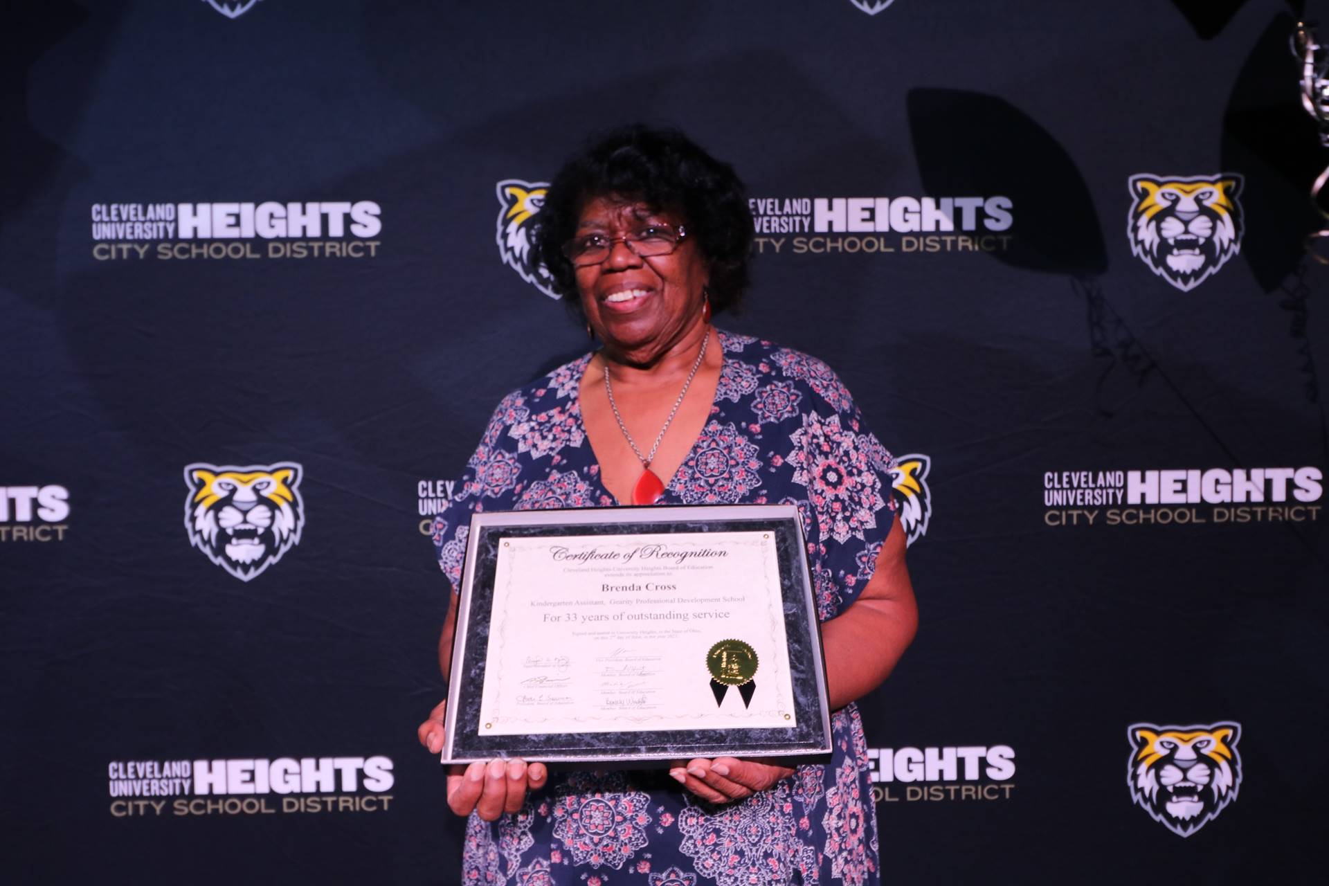 staff member holding award