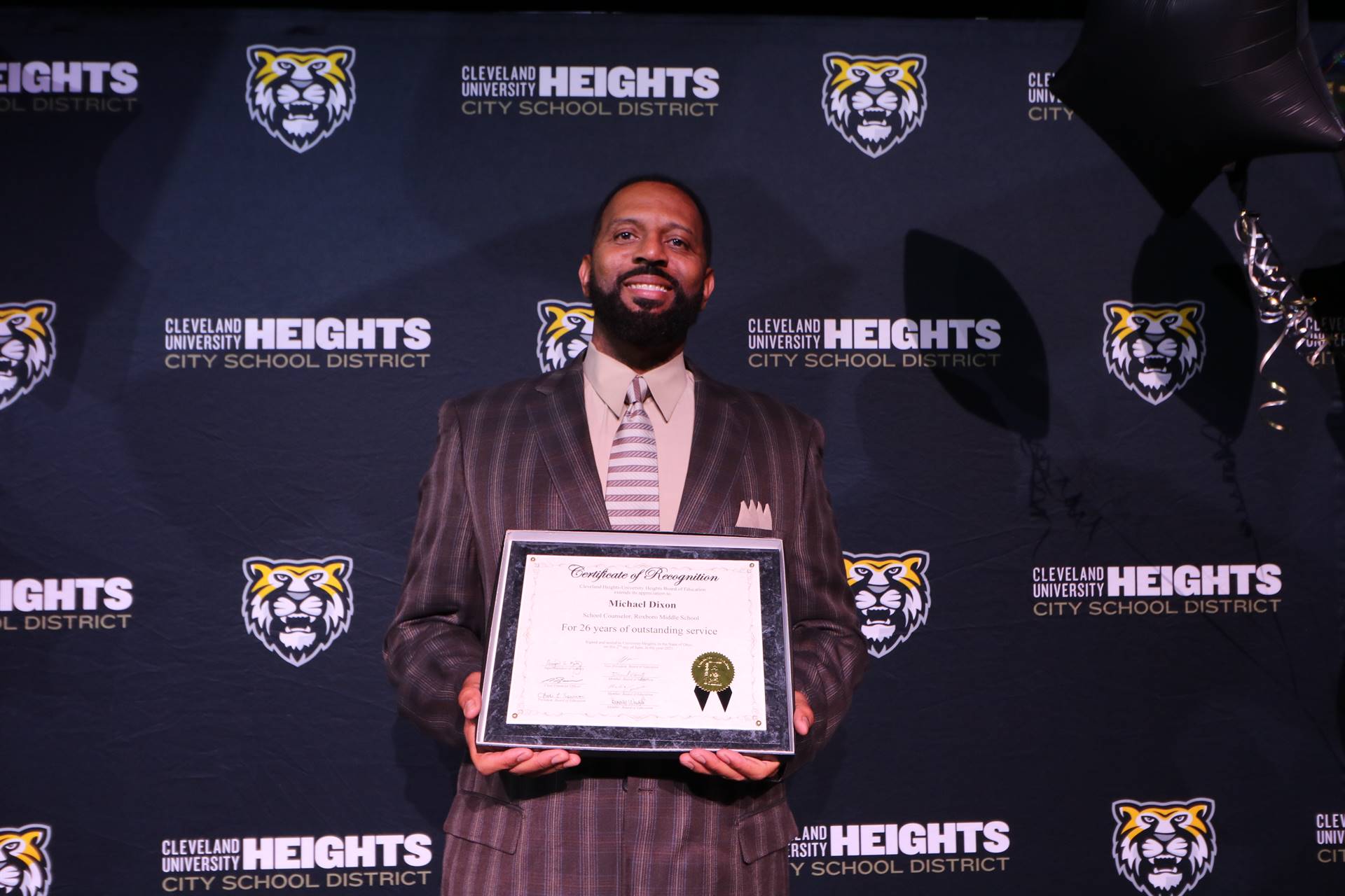 staff member holding award