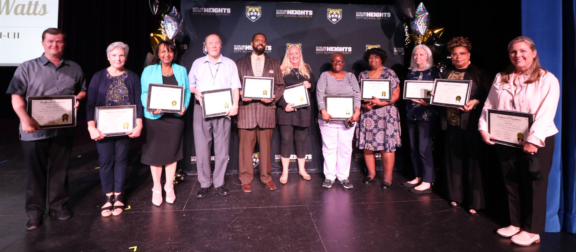 staff members holding awards