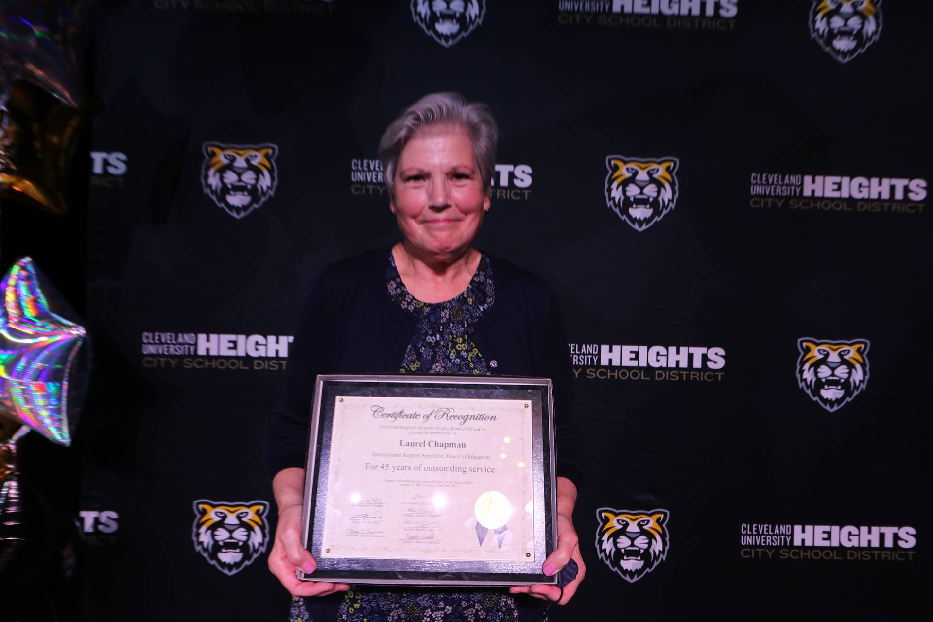 staff member holding award