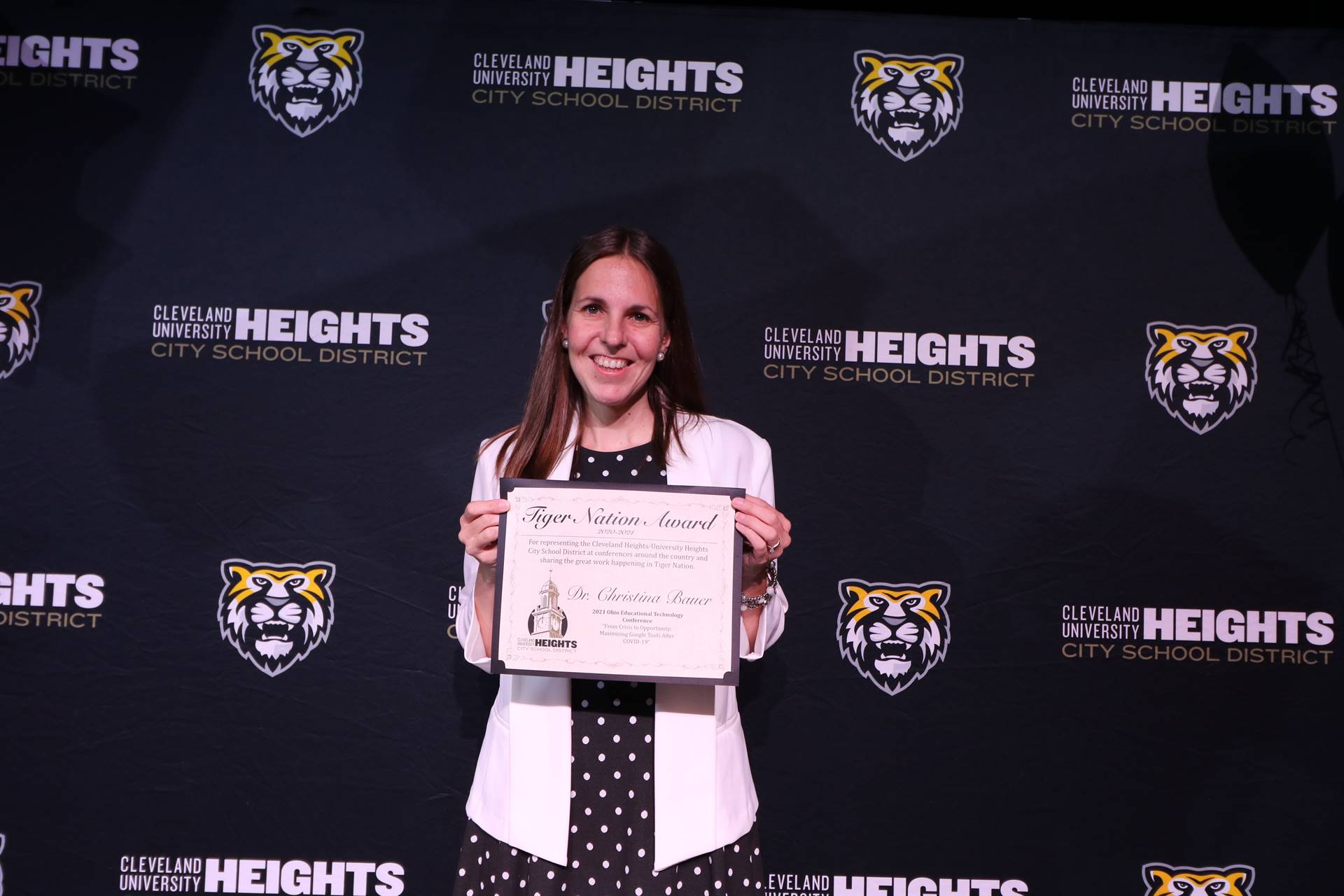 staff member holding award