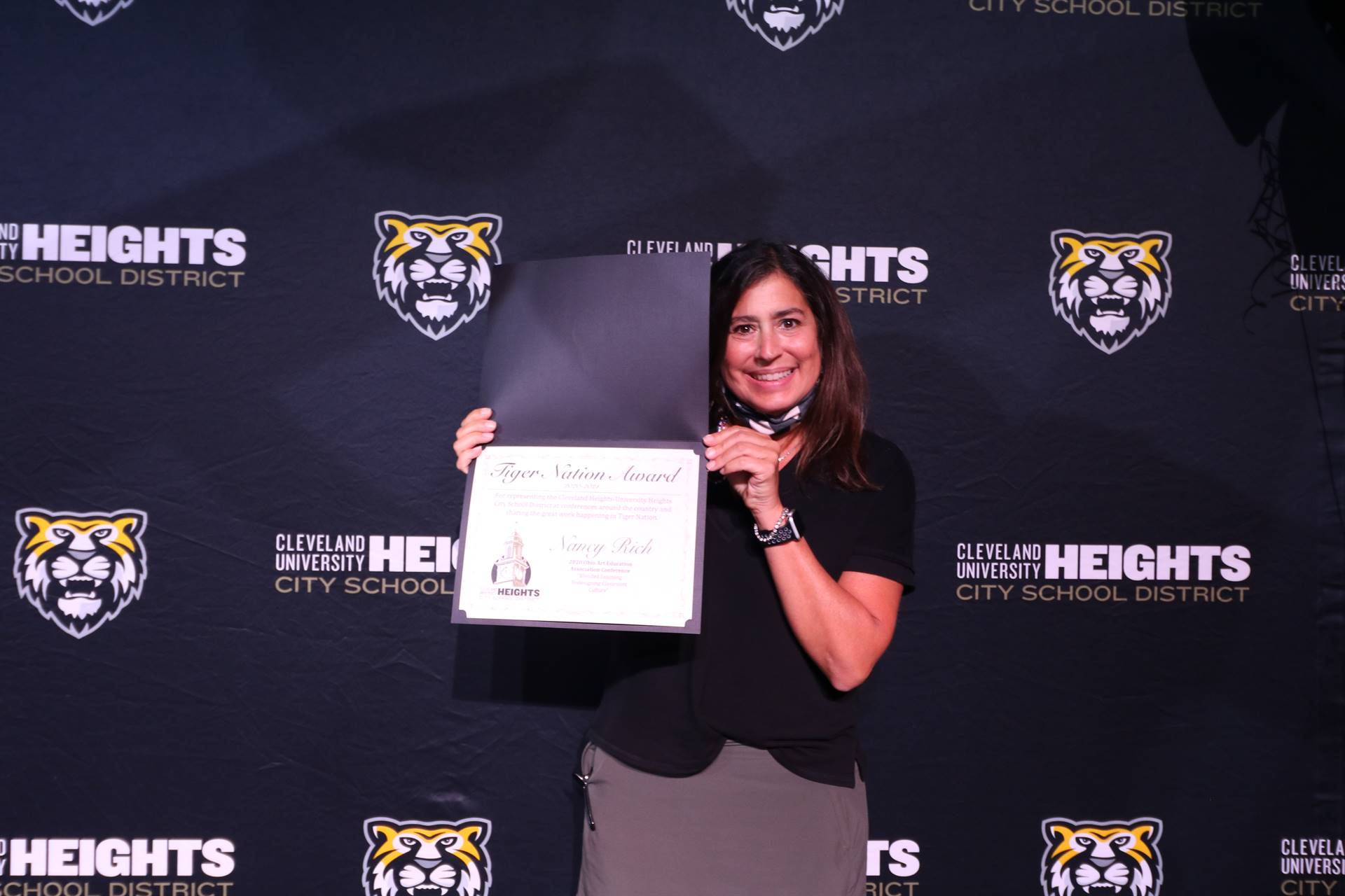 staff member holding award