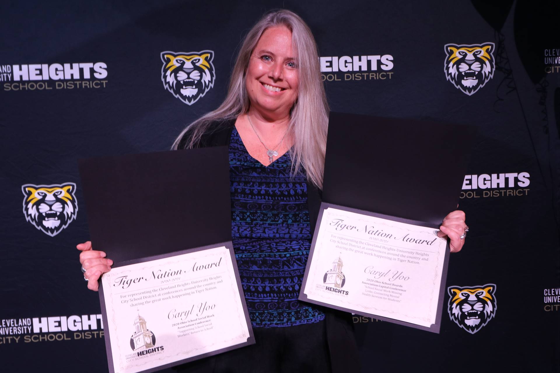 staff member holding award