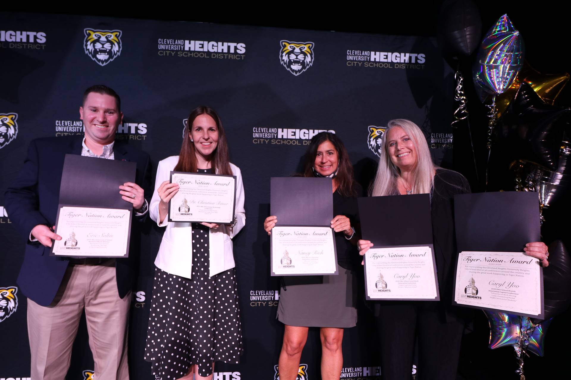 staff member holding award