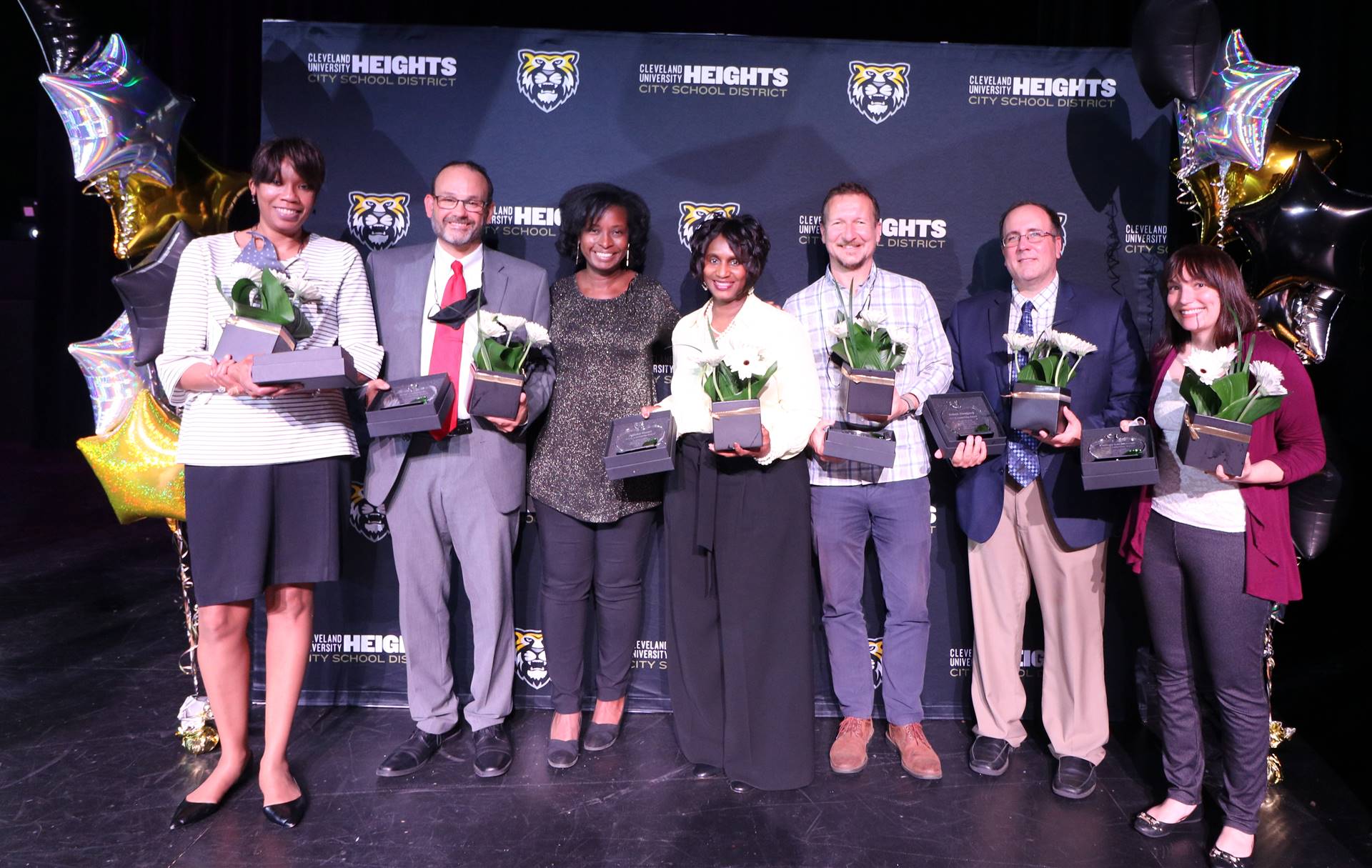 staff members holding awards