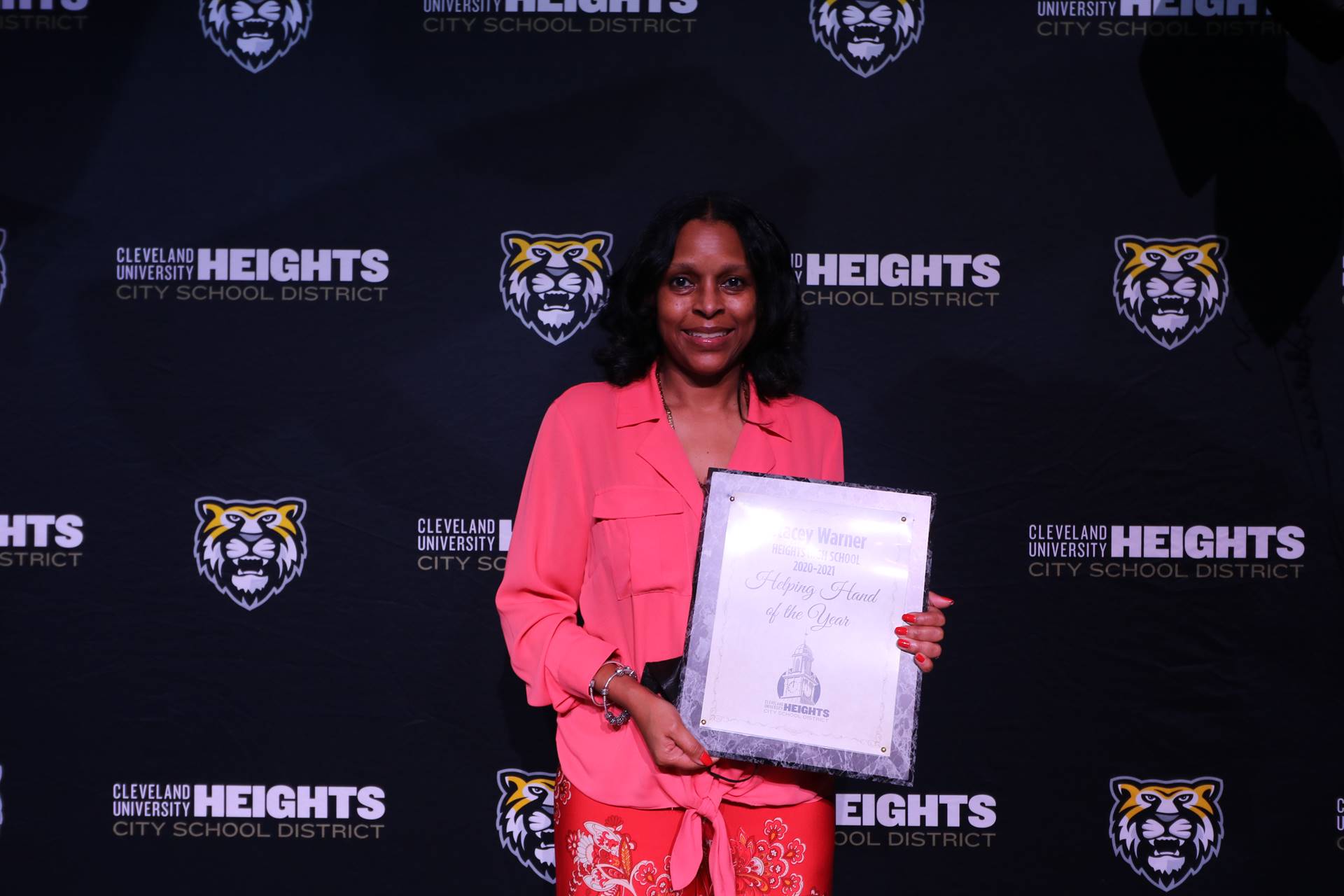 staff member holding award