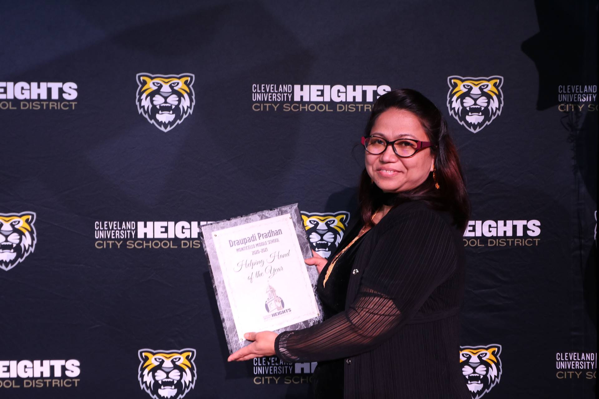 staff member holding award