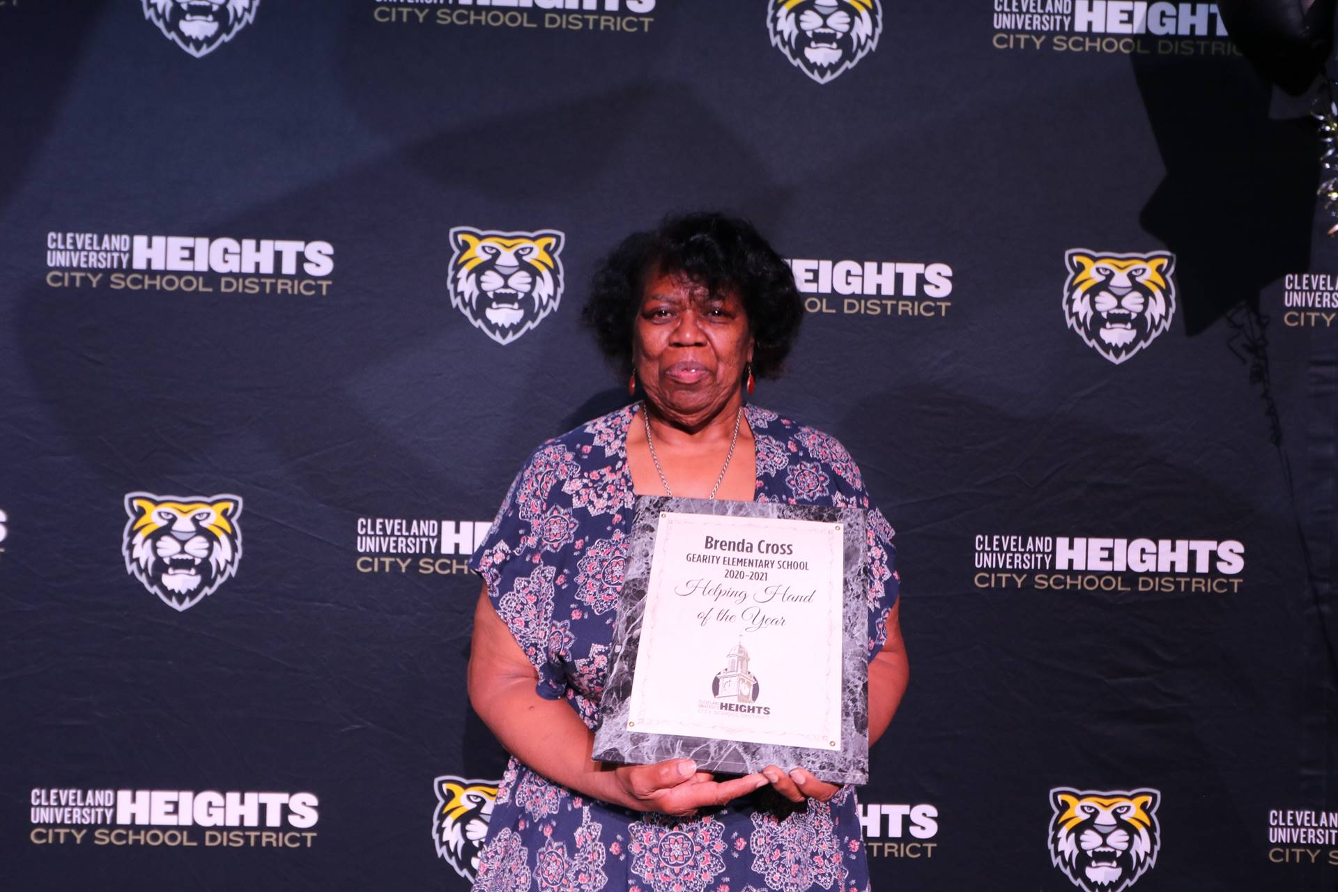 staff member holding award