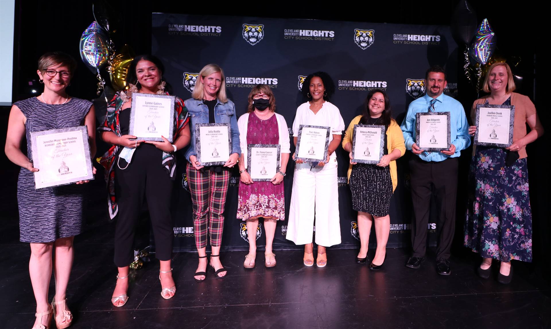 staff members holding awards