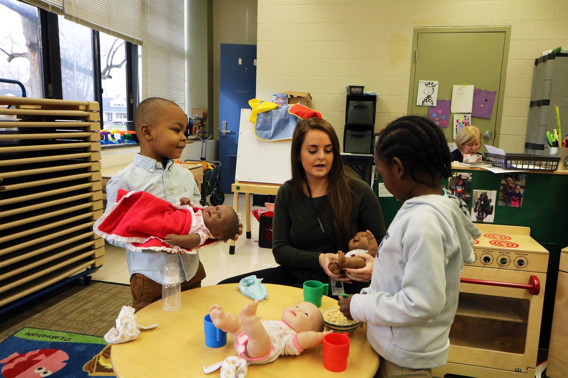 two children with teacher